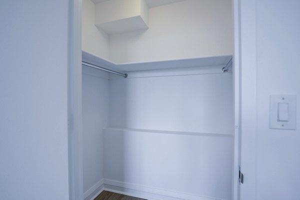 Spacious bedroom closet with modern shelving at 800 Sixth Apartments, offering organized storage solutions in a luxury rental