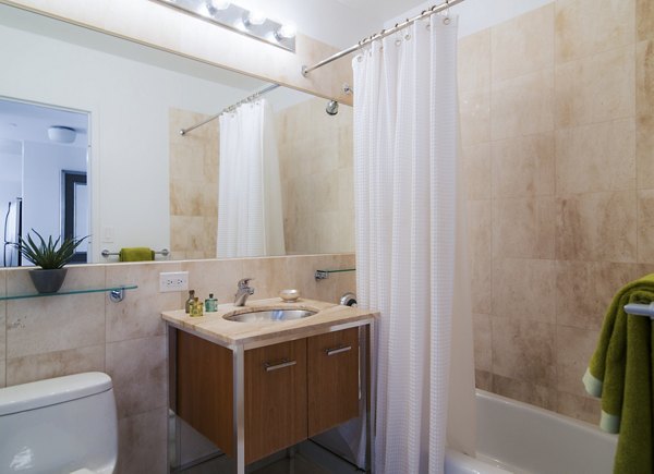 Bathroom featuring sleek countertops and modern fixtures at 800 Sixth Apartments