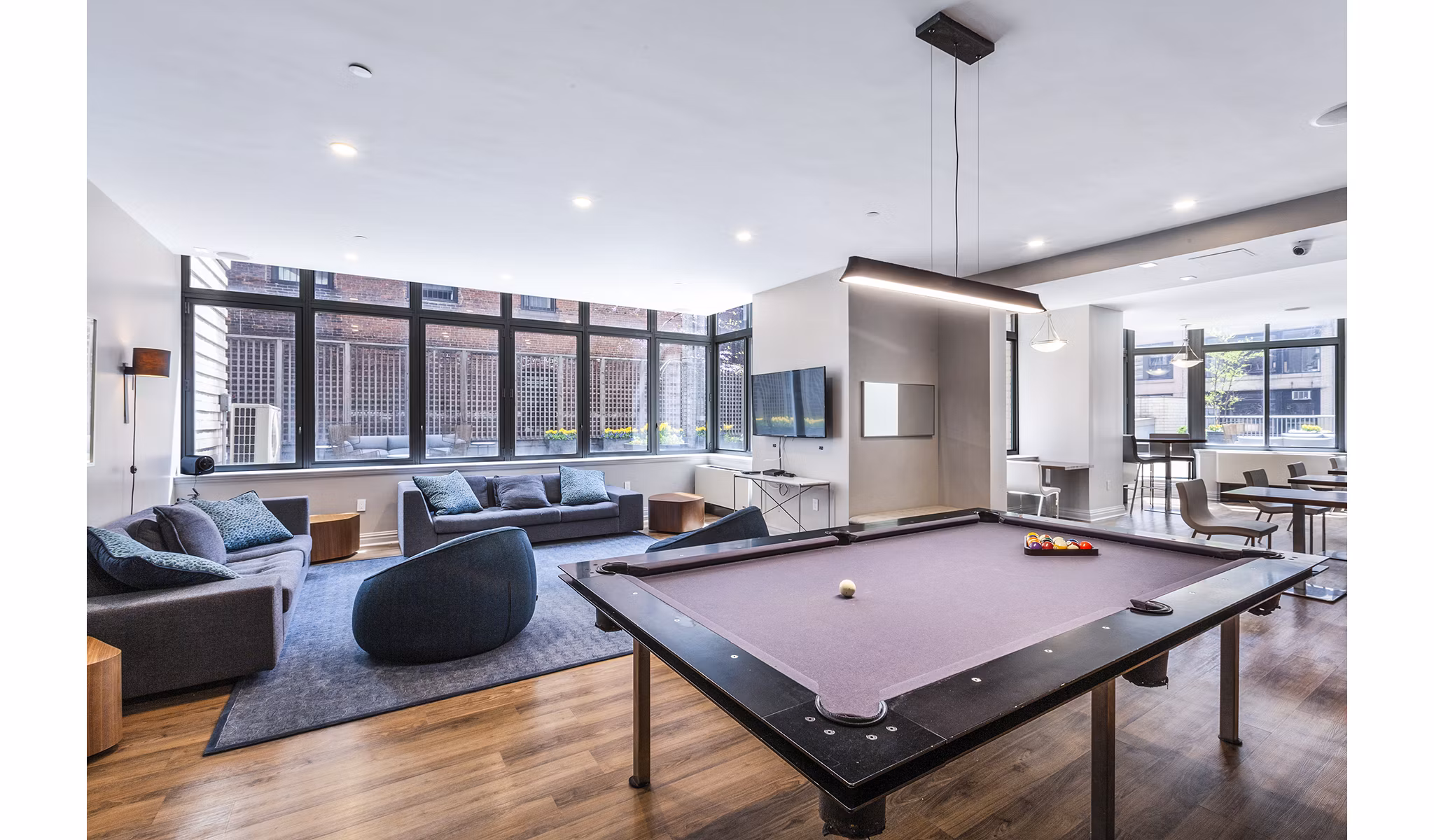 Game room featuring pool tables and arcade games in 800 Sixth Apartments
