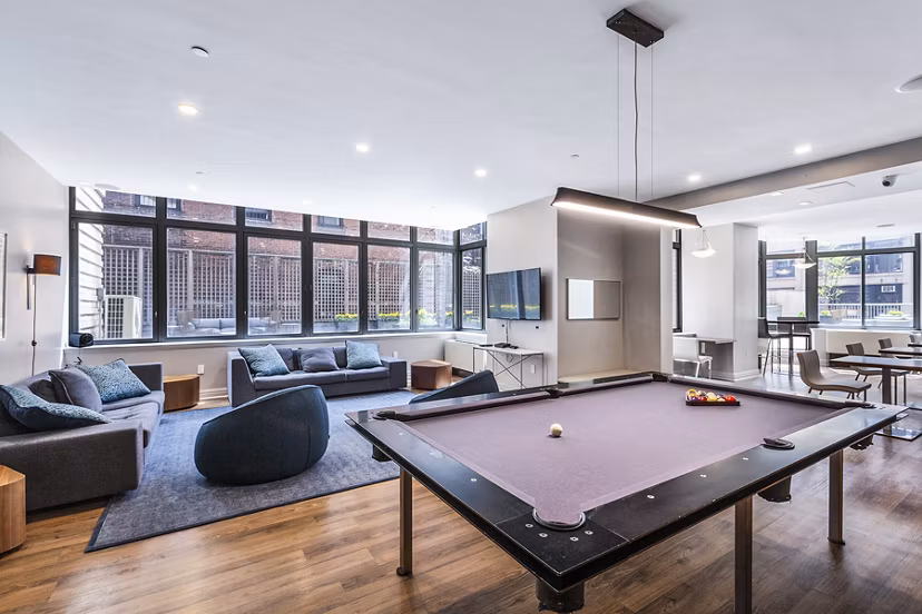 Game room featuring pool tables and arcade games in 800 Sixth Apartments