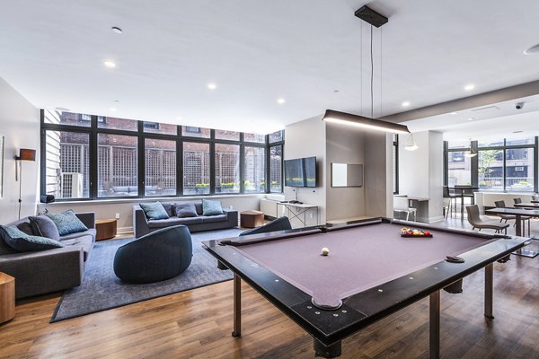 Game room featuring pool tables and arcade games in 800 Sixth Apartments