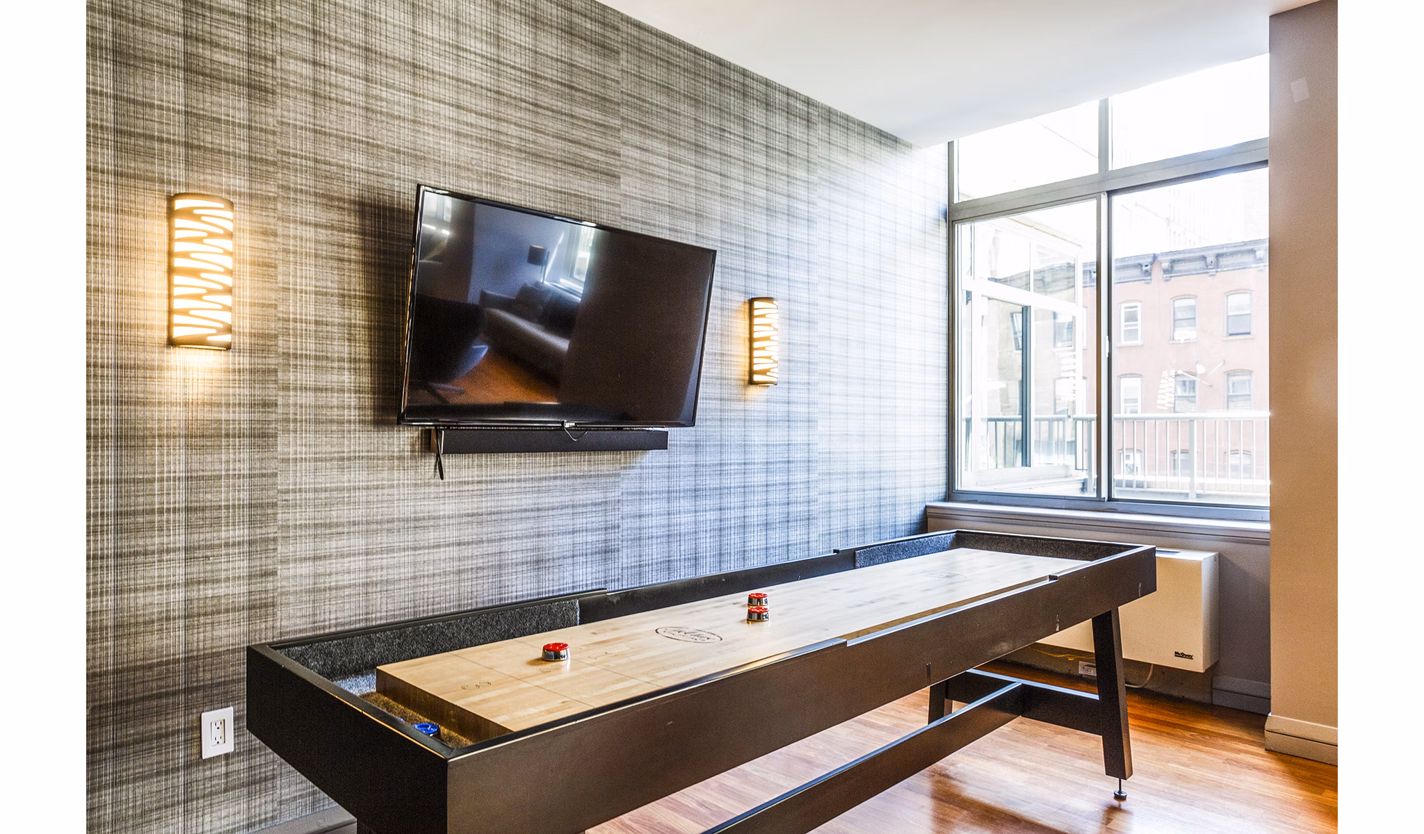 Game room with pool table and lounge seating at 800 Sixth Apartments