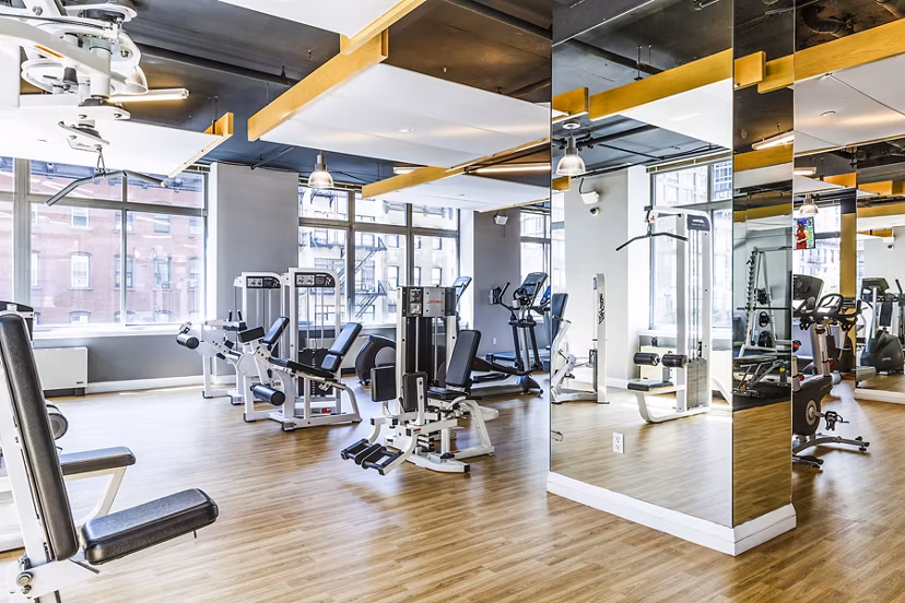 Modern fitness center with state-of-the-art equipment at 800 Sixth Apartments