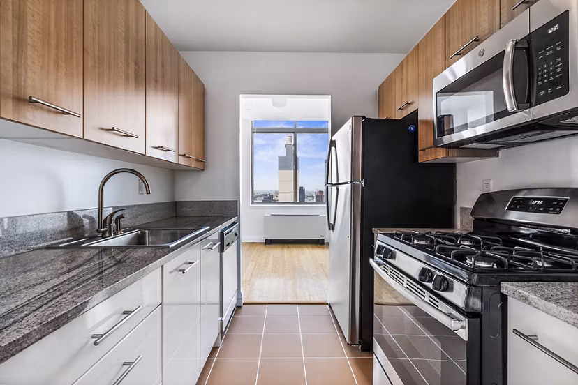 Modern kitchen with sleek countertops and stainless steel appliances at 800 Sixth Apartments