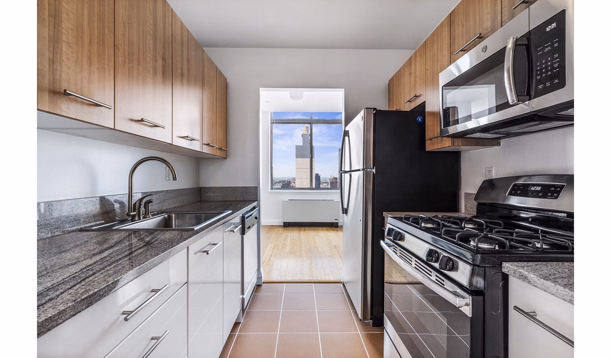 Modern kitchen with sleek countertops and stainless steel appliances at 800 Sixth Apartments