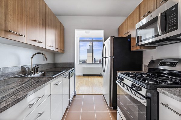 Modern kitchen with sleek countertops and stainless steel appliances at 800 Sixth Apartments