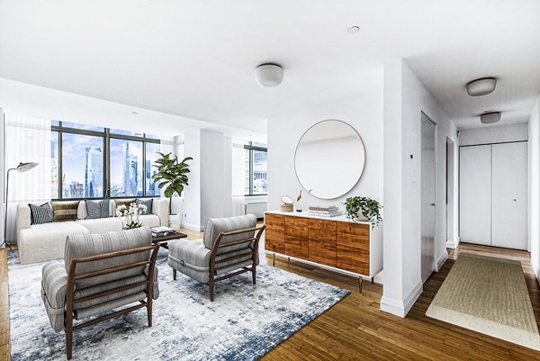 Modern living room with chic furnishings and city views at 800 Sixth Apartments