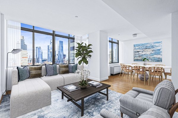 Living room with modern furnishings and large windows at 800 Sixth Apartments