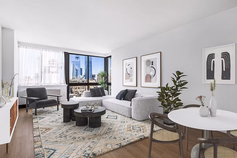Living room with modern decor and large windows at 800 Sixth Apartments