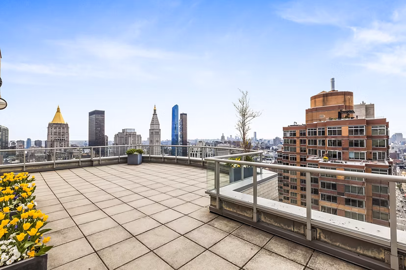 Cozy patio overlooking cityscape at 800 Sixth Apartments, perfect for relaxation and outdoor dining in a luxury setting