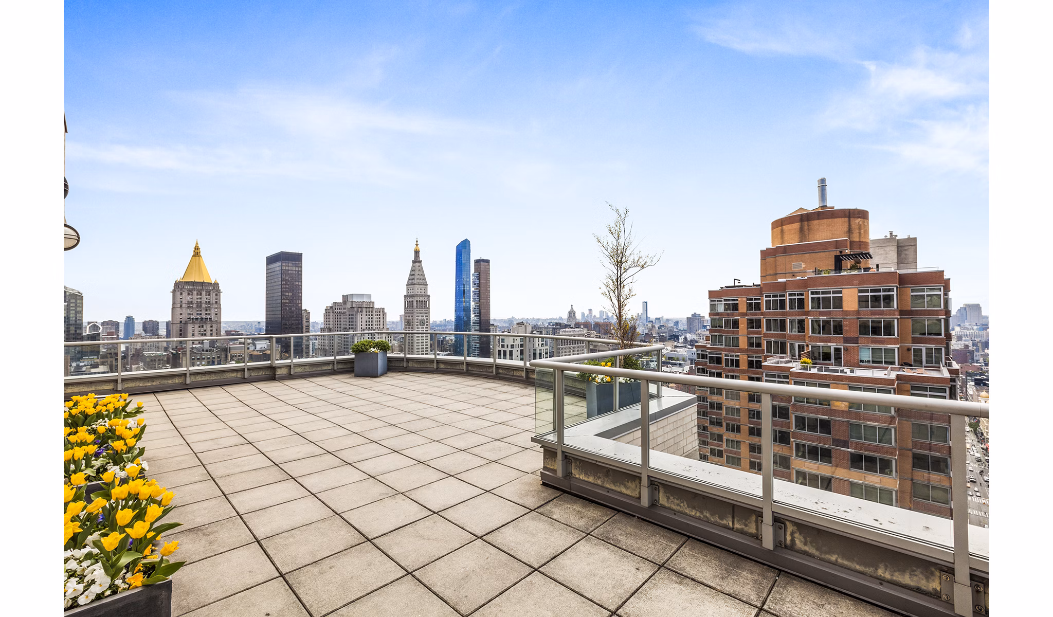 Cozy patio overlooking cityscape at 800 Sixth Apartments, perfect for relaxation and outdoor dining in a luxury setting