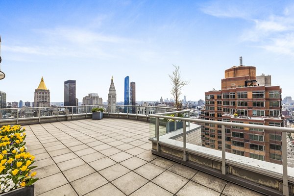 Cozy patio overlooking cityscape at 800 Sixth Apartments, perfect for relaxation and outdoor dining in a luxury setting