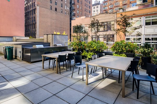 Modern grill area with comfortable seating at 800 Sixth Apartments, luxury community by Greystar