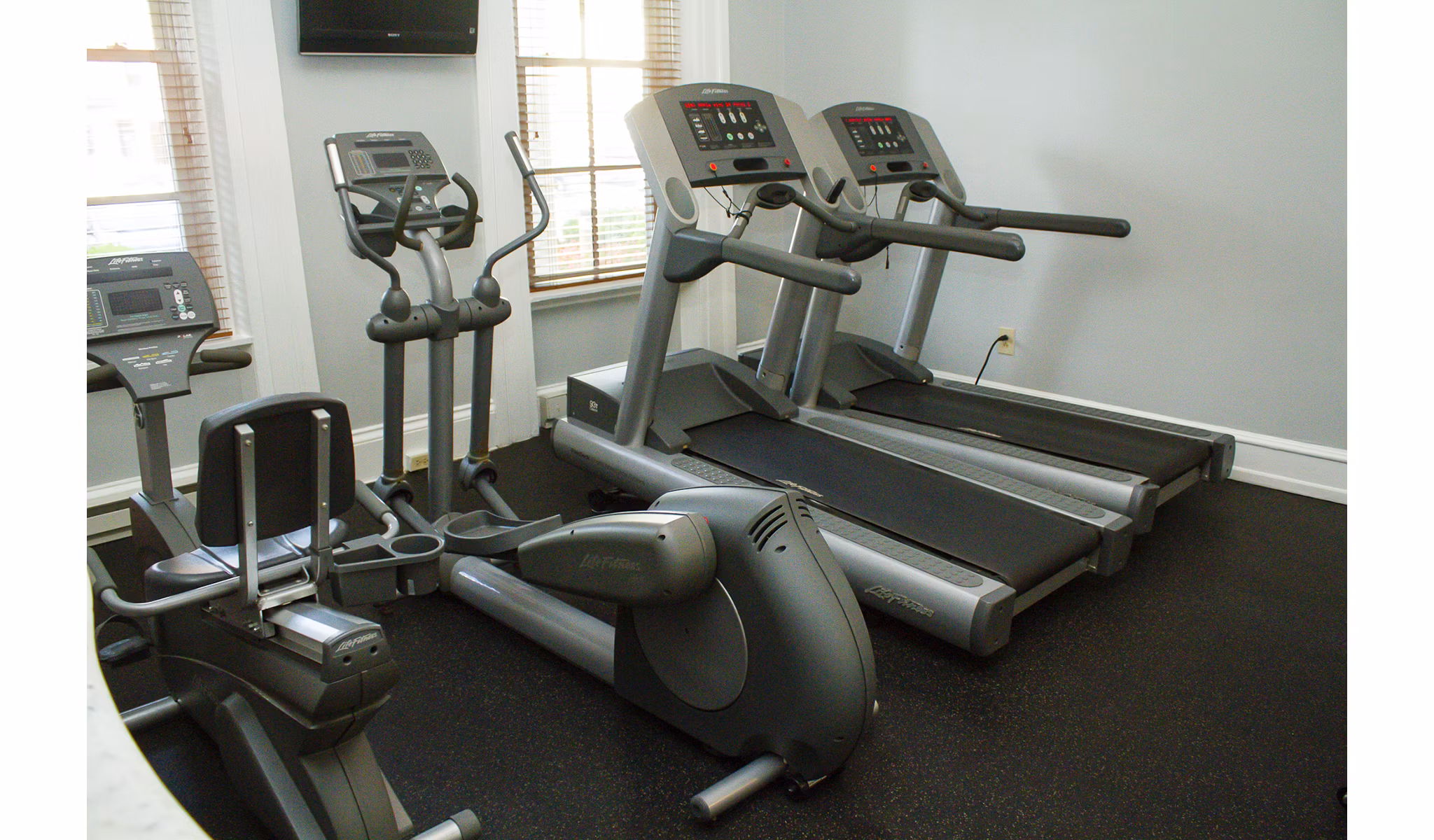 State-of-the-art fitness center with modern equipment at Old Quaker Building Apartments