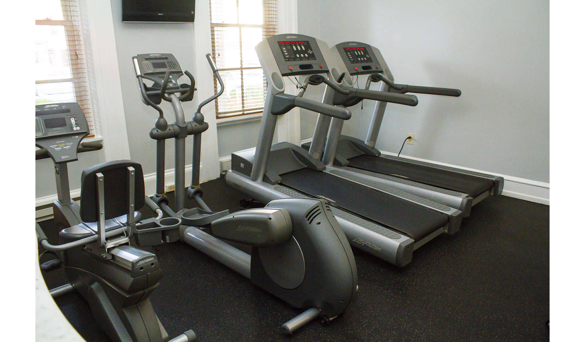State-of-the-art fitness center with modern equipment at Old Quaker Building Apartments