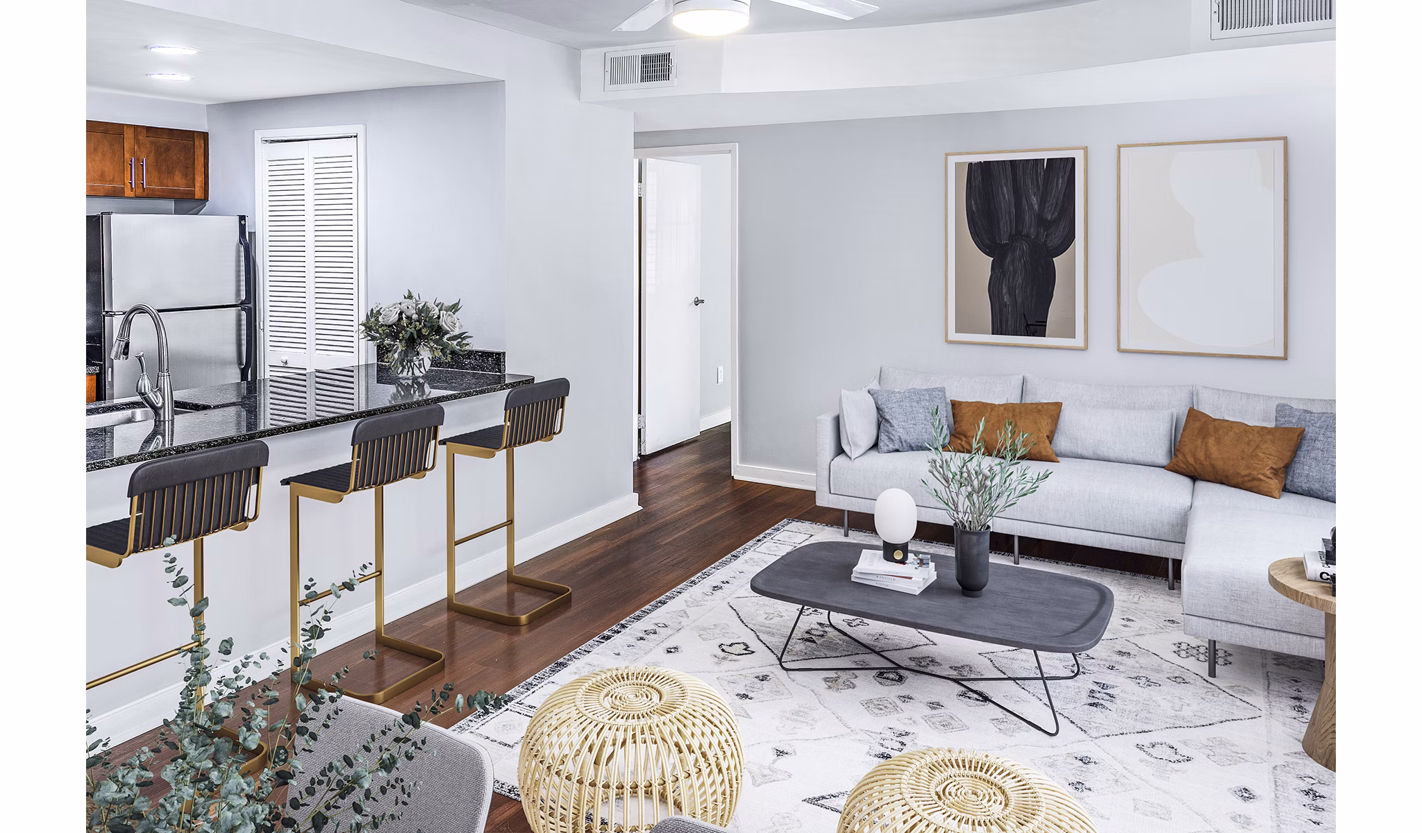 Spacious living room with modern decor in Quaker Court at University City Apartments