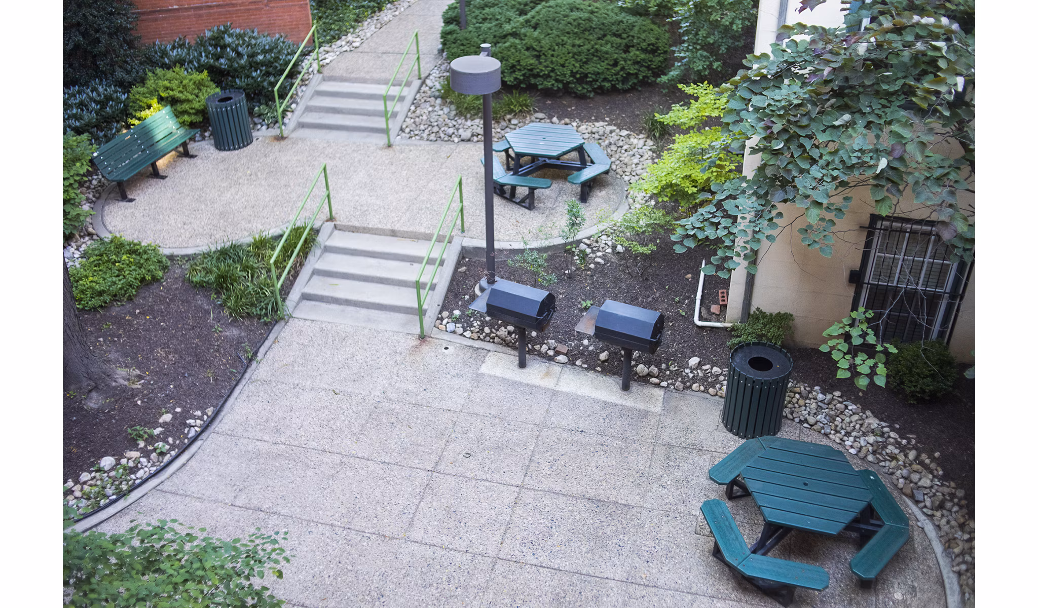 Outdoor grill area with modern seating at Old Quaker Building Apartments, ideal for social gatherings and cooking enthusiasts