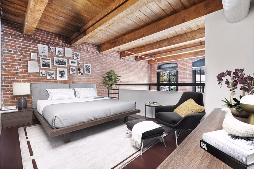 Cozy bedroom with large windows in Logan Lofts apartments