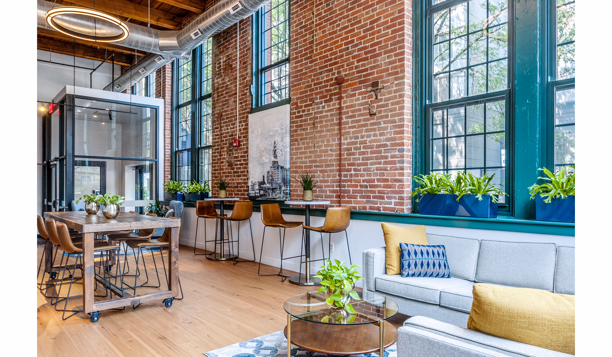 Clubhouse with modern decor and ample seating at Logan Lofts Apartments