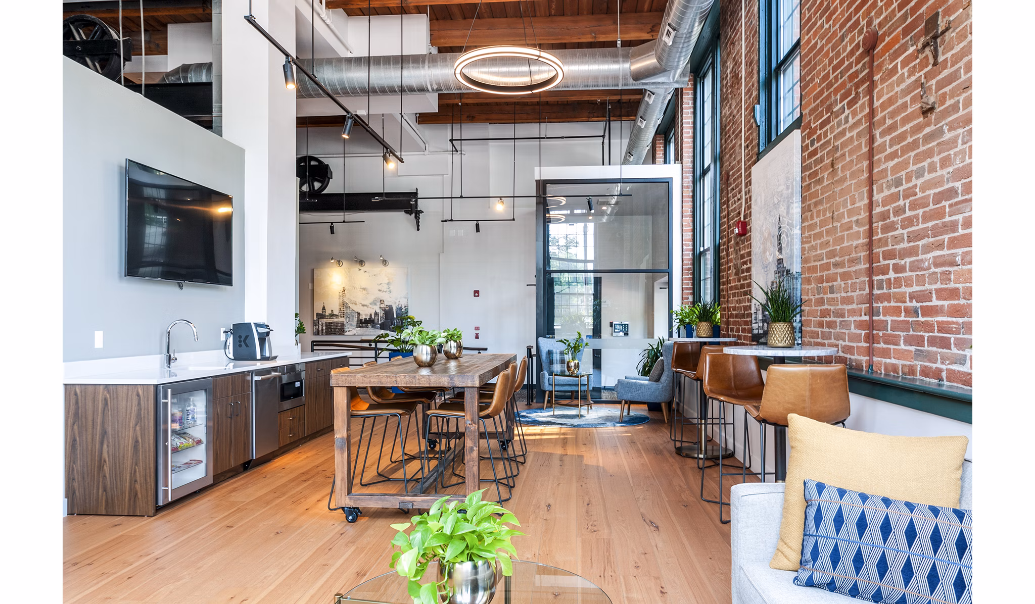 Clubhouse with modern decor and seating at Logan Lofts Apartments, perfect for gatherings and social events in a stylish setting