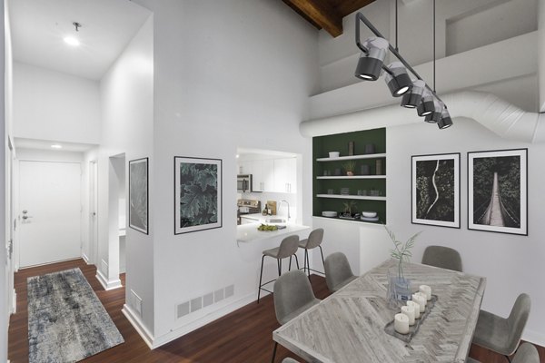 Dining area with modern fixtures and elegant seating at Logan Lofts luxury apartments, perfect for hosting gatherings and meals