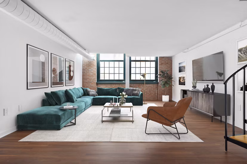 Modern living room with large windows and stylish furniture in Logan Lofts luxury apartments