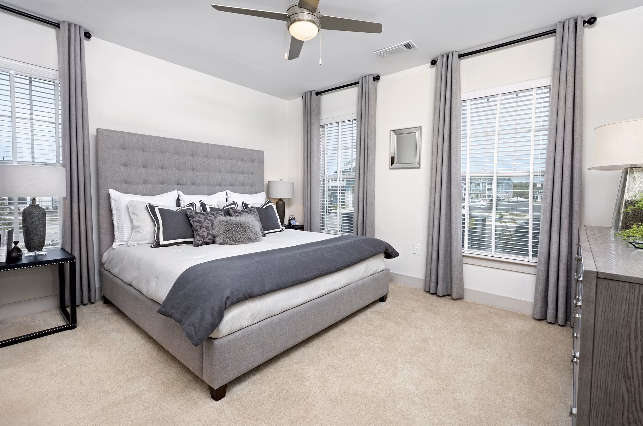 Bedroom featuring modern decor and plush bedding at Avia Apartments