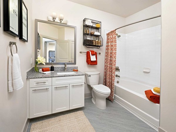 Luxurious bathroom with modern fixtures at Avia Apartments: contemporary luxury living in vibrant city setting