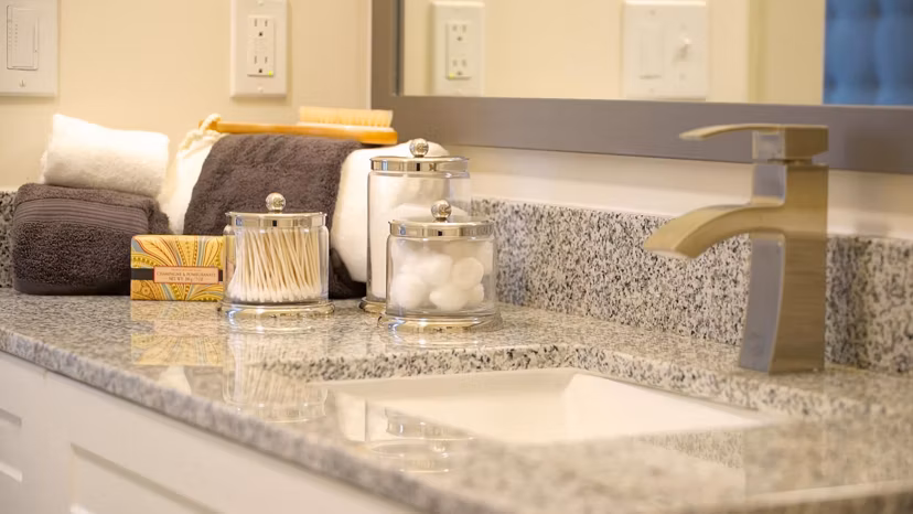 Modern bathroom with marble countertops at Avia Apartments