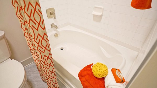 Luxurious bathroom featuring sleek fixtures and a spacious vanity in Avia Apartments