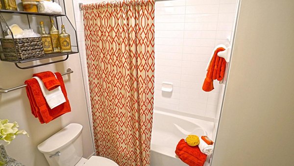 Bathroom with modern fixtures and sleek marble countertops at Avia Apartments