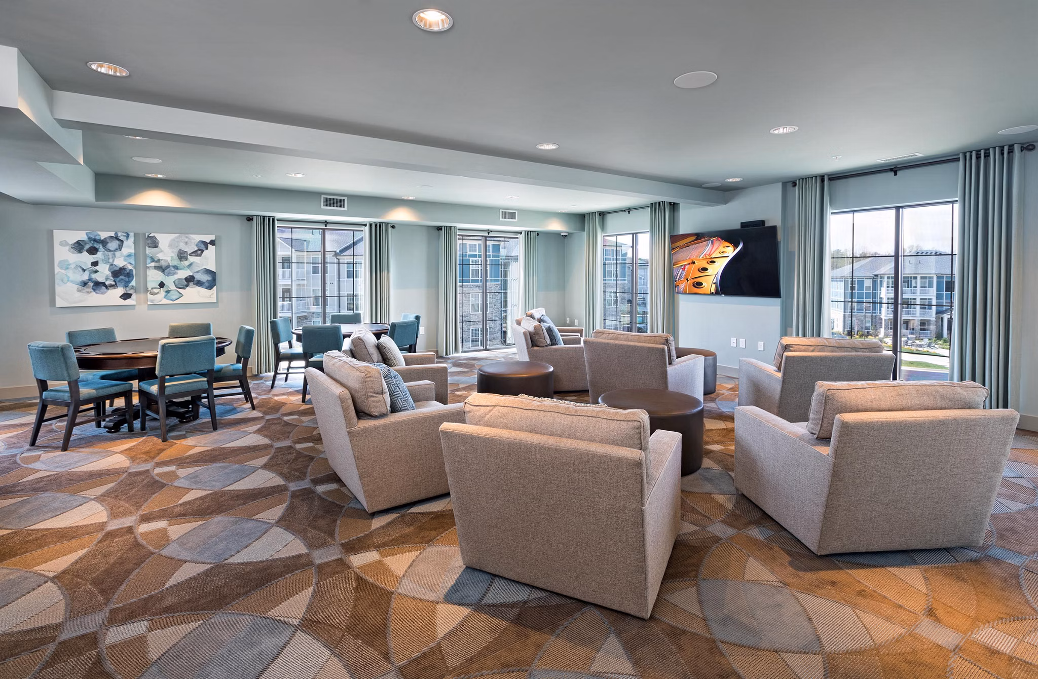 Elegant clubhouse with modern seating at Avia Apartments, perfect for gatherings and social events in a luxury community setting