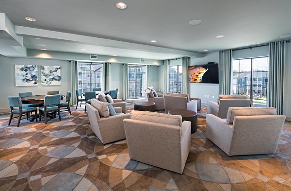 Elegant clubhouse with modern seating at Avia Apartments, perfect for gatherings and social events in a luxury community setting