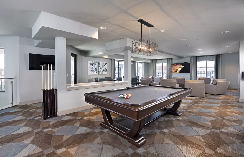 Stylish clubhouse at Avia Apartments featuring modern decor and ample seating for residents to relax and socialize
