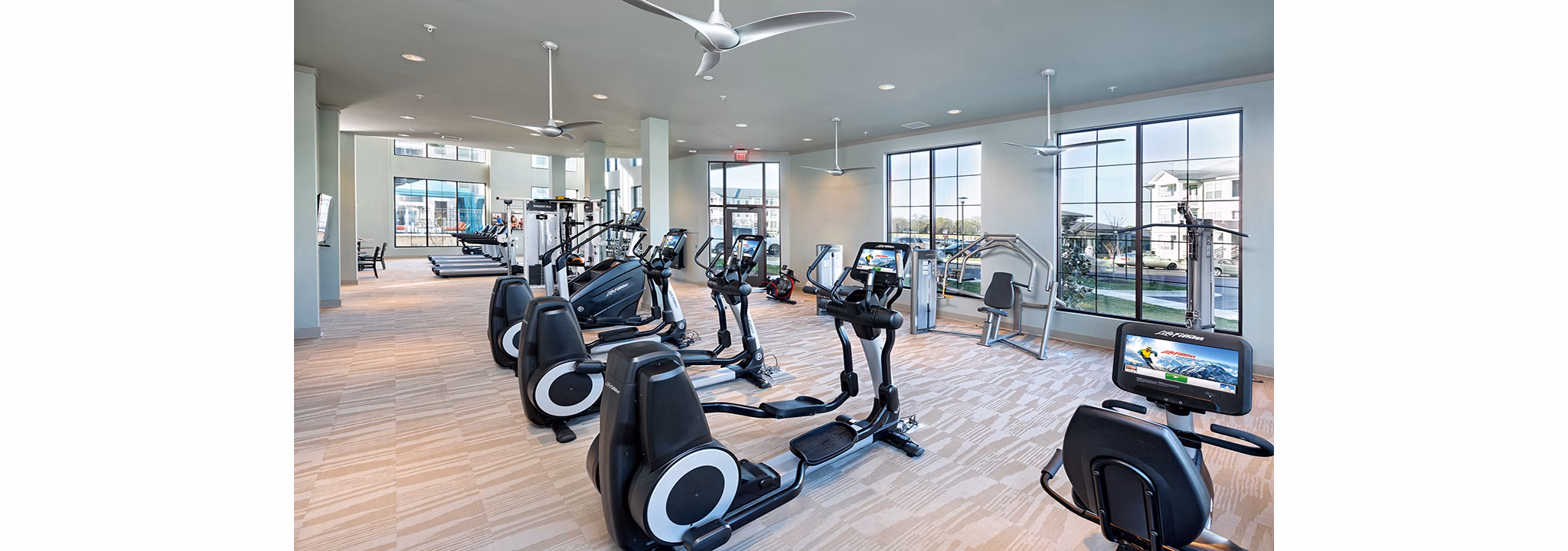 Modern fitness center with state-of-the-art equipment at Avia Apartments