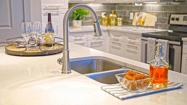 Modern kitchen with stainless steel appliances and quartz countertops at Avia Apartments