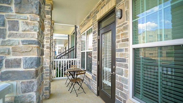 Modern patio with comfortable seating at Avia Apartments, perfect for outdoor dining and relaxation