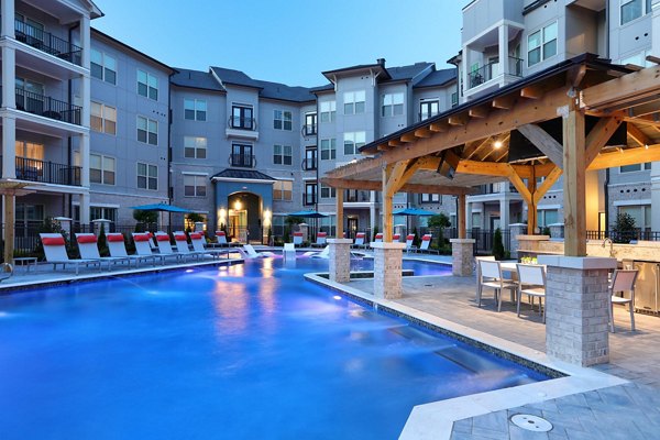 Relax by the sparkling pool at Avia Apartments, a luxurious living community offering premium amenities and stylish outdoor spaces