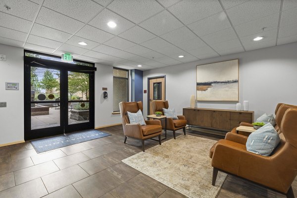 Modern clubhouse interior with cozy seating and large windows at Destinations Lynnwood Apartments