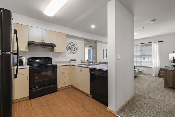 Modern kitchen with stainless steel appliances in Destinations Lynnwood Apartments