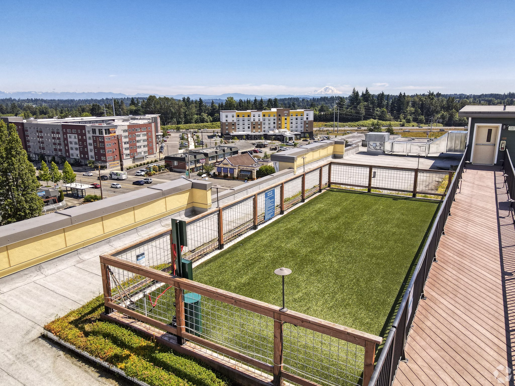 Spacious dog park at Destinations Lynnwood Apartments featuring agility equipment and green spaces for pet-friendly luxury living