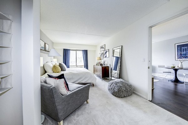 Modern bedroom with bay window and waterfront views at Half Moon Harbour Apartments