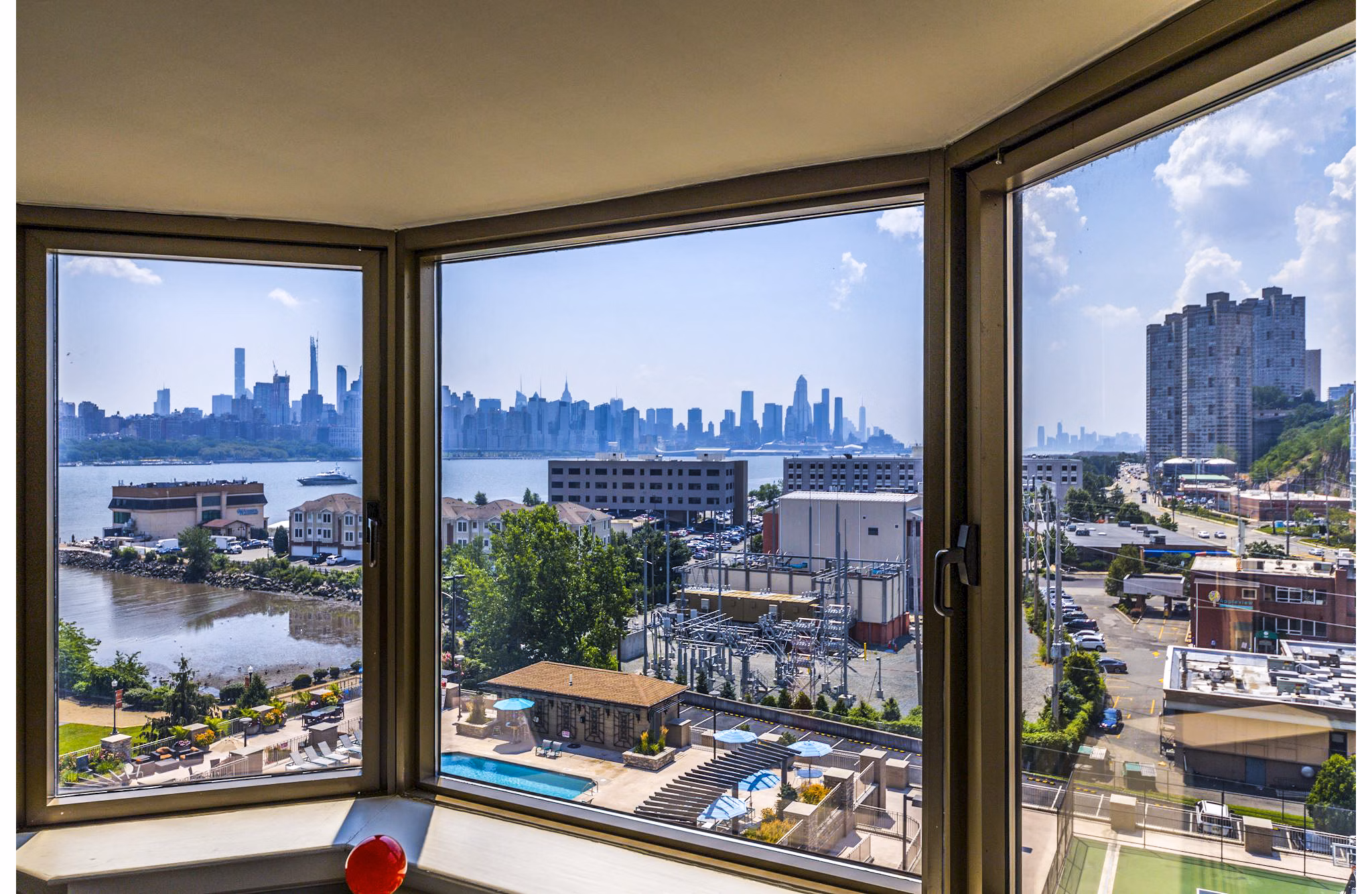 Spacious living room with stunning river view at Half Moon Harbour Apartments