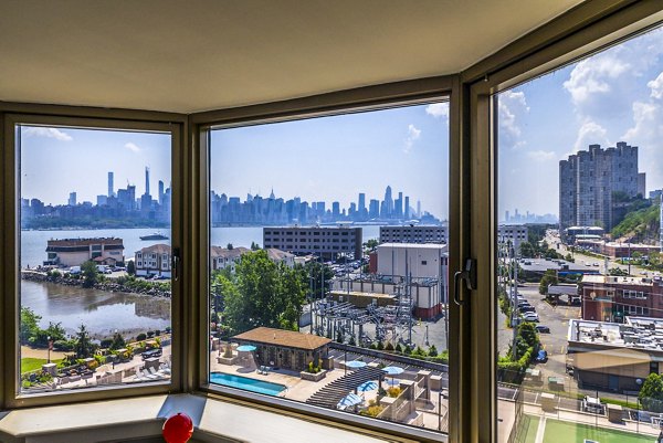 Spacious living room with stunning river view at Half Moon Harbour Apartments