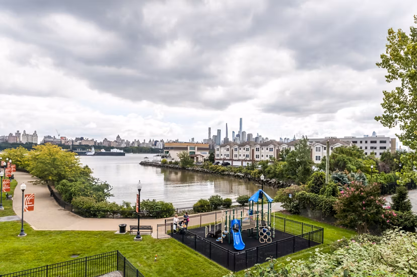 Outdoor playground with modern play structures at Half Moon Harbour Apartments