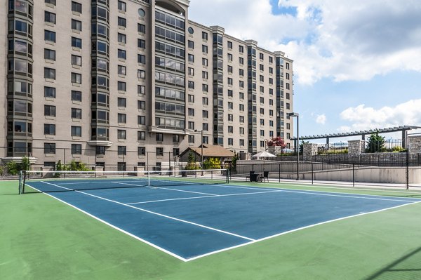 Tennis court with waterfront views at Half Moon Harbour Apartments