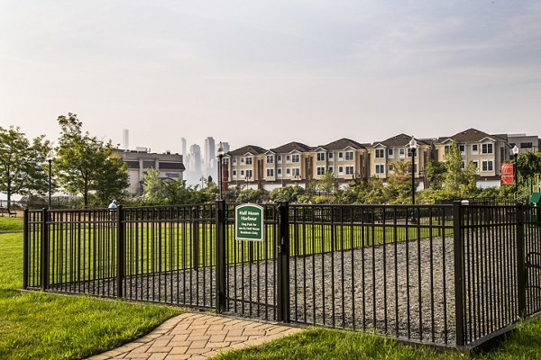 Dog park with agility equipment at Half Moon Harbour Apartments, offering a pet-friendly community space for residents