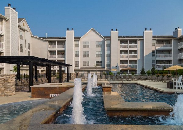 Relaxing outdoor pool area at Mountain View Crossing luxury apartments, surrounded by lush greenery