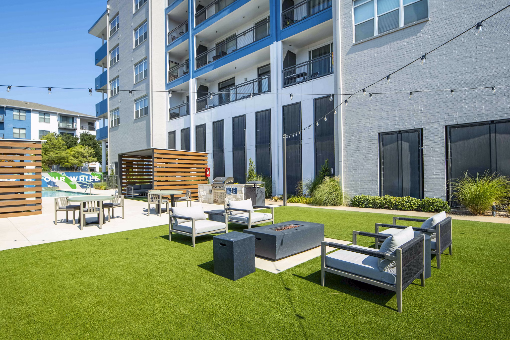 Outdoor grill area and fire pit on patio at Broadstone on Trinity Apartments, perfect for entertaining and relaxation
