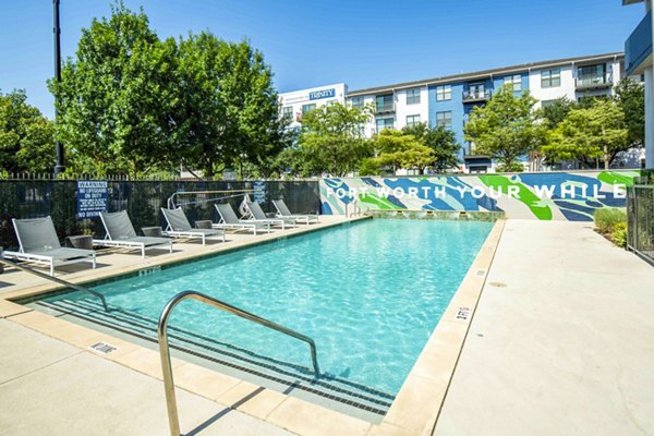 Outdoor pool with cabanas at Broadstone on Trinity Apartments in Austin, luxury living with relaxation and leisure amenities